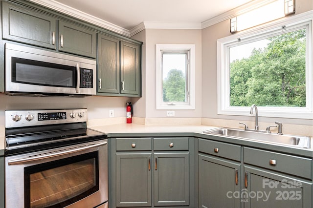 2728 Touchstone Cir, Newton, NC 28658 - kitchen with appliances with stainless steel finishes, a sink, plenty of natural light, light countertops, and ornamental molding