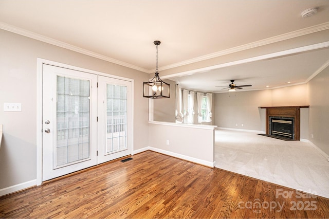 2728 Touchstone Cir, Newton, NC 28658 - unfurnished living room with baseboards, wood finished floors, crown molding, a fireplace with flush hearth, and a ceiling fan