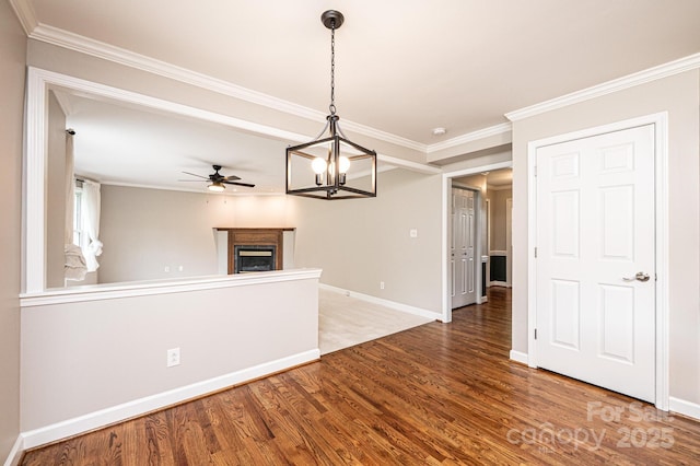 2728 Touchstone Cir, Newton, NC 28658 - unfurnished living room with wood finished floors, ceiling fan, crown molding, a chandelier, and a fireplace