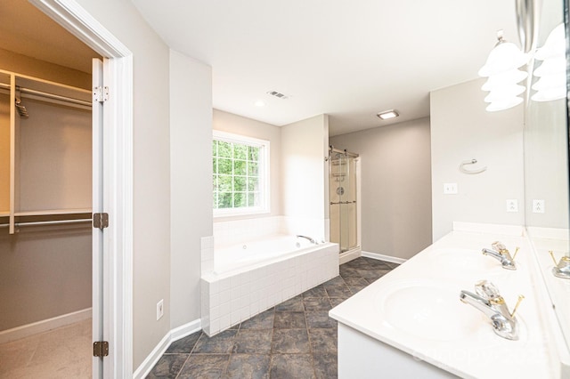 2728 Touchstone Cir, Newton, NC 28658 - full bathroom with a stall shower, a spacious closet, a garden tub, baseboards, and double vanity