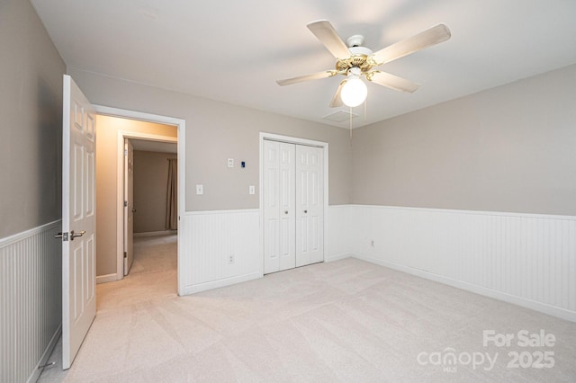2728 Touchstone Cir, Newton, NC 28658 - unfurnished bedroom featuring wainscoting, light colored carpet, a closet, and a ceiling fan