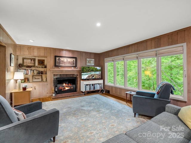 185 Greenstoke Loop, Tryon, NC 28782 - living area featuring wooden walls, a glass covered fireplace, and wood finished floors