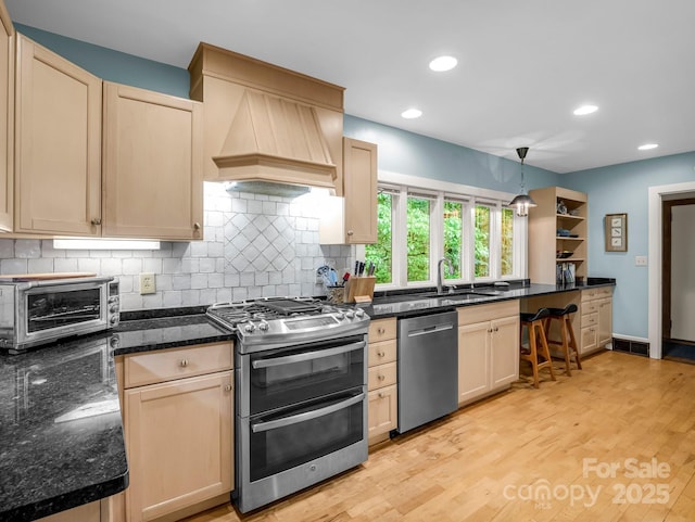 185 Greenstoke Loop, Tryon, NC 28782 - kitchen featuring stainless steel appliances, decorative backsplash, a sink, light brown cabinets, and recessed lighting