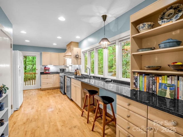 185 Greenstoke Loop, Tryon, NC 28782 - kitchen featuring a sink, stainless steel appliances, light brown cabinetry, decorative backsplash, and light wood-style flooring