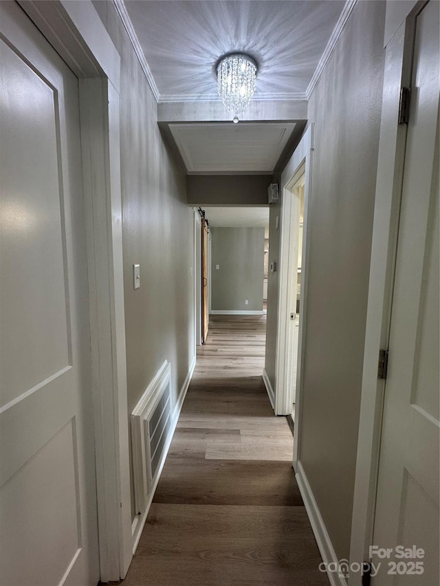 4524 Cinderella Rd, Charlotte, NC 28213 - hallway featuring wood finished floors, a chandelier, ornamental molding, and baseboards