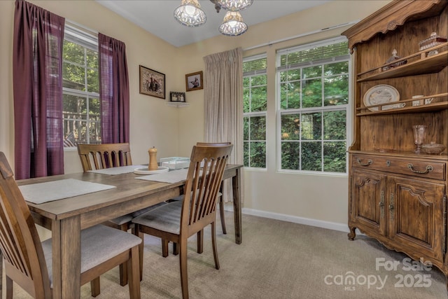 619 Beaverdam Rd, Asheville, NC 28804 - dining room with light carpet, a chandelier, and baseboards