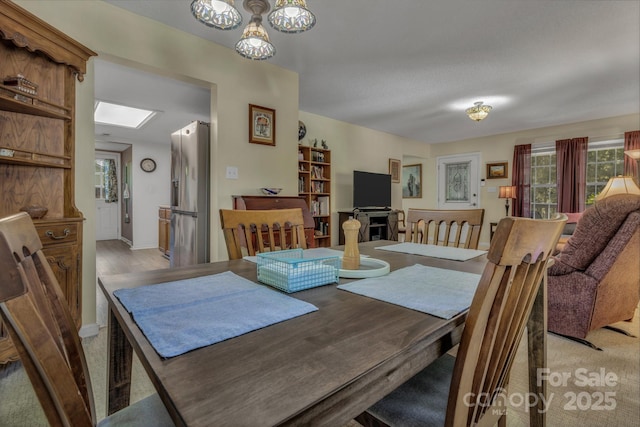 619 Beaverdam Rd, Asheville, NC 28804 - dining room featuring a chandelier, a skylight, and baseboards