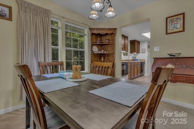 619 Beaverdam Rd, Asheville, NC 28804 - dining space featuring baseboards, a chandelier, and light colored carpet