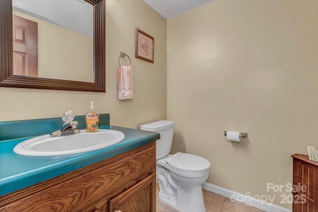 619 Beaverdam Rd, Asheville, NC 28804 - half bath with vanity, toilet, tile patterned flooring, and baseboards