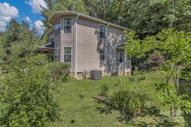 619 Beaverdam Rd, Asheville, NC 28804 - view of home's exterior featuring central AC unit, a yard, and view of scattered trees