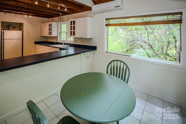 680 Timberlane Dr, Boone, NC 28607 - kitchen with freestanding refrigerator, track lighting, a sink, a wall mounted AC, and dark countertops