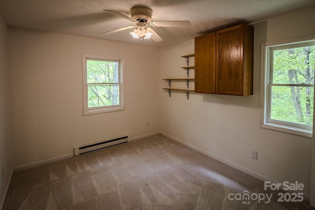680 Timberlane Dr, Boone, NC 28607 - spare room with a baseboard heating unit, healthy amount of natural light, ceiling fan, a textured ceiling, and carpet flooring