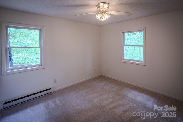 680 Timberlane Dr, Boone, NC 28607 - carpeted spare room featuring a baseboard heating unit, a ceiling fan, baseboards, and a textured ceiling