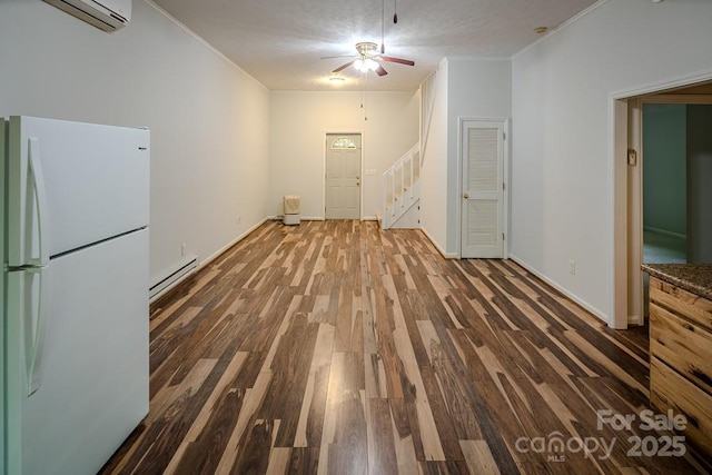 680 Timberlane Dr, Boone, NC 28607 - spare room featuring a baseboard heating unit, wood finished floors, a wall unit AC, ceiling fan, and stairway