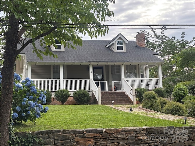 143 Broadway Ave, Tryon, NC 28782 - cape cod-style house featuring a chimney, roof with shingles, a front yard, and a porch