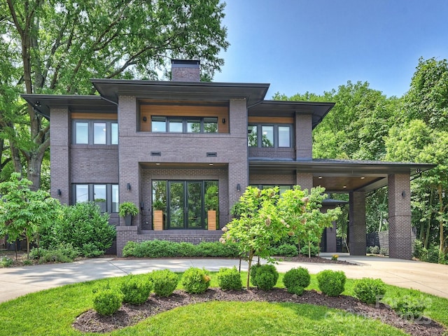 112 Manning Dr, Charlotte, NC 28209 - view of front facade featuring brick siding, curved driveway, and a chimney