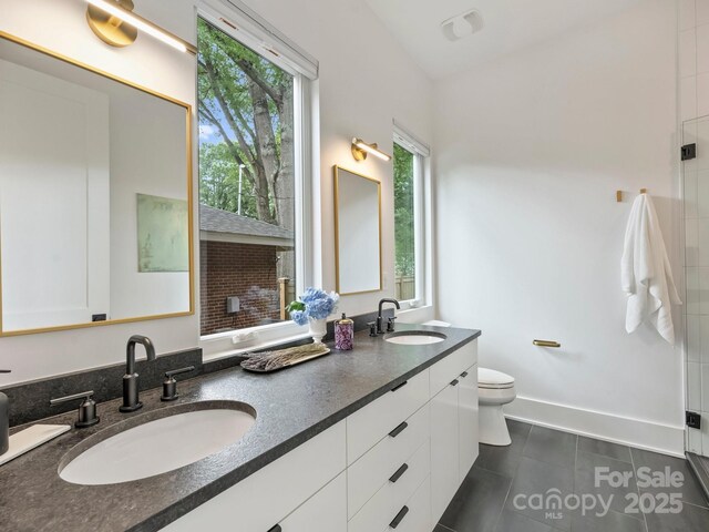 112 Manning Dr, Charlotte, NC 28209 - full bathroom with toilet, double vanity, tile patterned flooring, and a shower with shower door