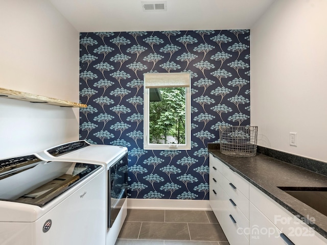 112 Manning Dr, Charlotte, NC 28209 - laundry room featuring washing machine and clothes dryer, wallpapered walls, baseboards, and cabinet space