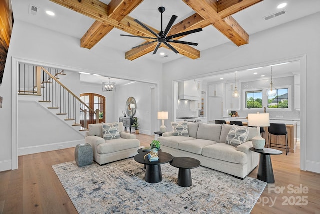 1405 Waxhaw Marvin Rd, Waxhaw, NC 28173 - living area with stairway, coffered ceiling, baseboards, light wood-style flooring, and beamed ceiling