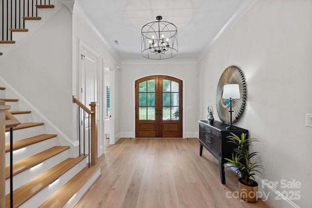 1405 Waxhaw Marvin Rd, Waxhaw, NC 28173 - foyer featuring stairway, light wood-type flooring, a chandelier, french doors, and ornamental molding