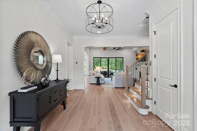 1405 Waxhaw Marvin Rd, Waxhaw, NC 28173 - entryway with light wood-style flooring, stairs, a chandelier, ornamental molding, and a ceiling fan