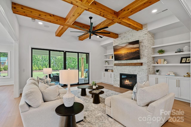 1405 Waxhaw Marvin Rd, Waxhaw, NC 28173 - living room featuring light wood-type flooring, baseboards, a stone fireplace, ceiling fan, and beam ceiling