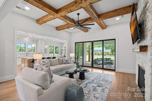 1405 Waxhaw Marvin Rd, Waxhaw, NC 28173 - living room featuring a stone fireplace, coffered ceiling, beam ceiling, baseboards, and light wood-type flooring