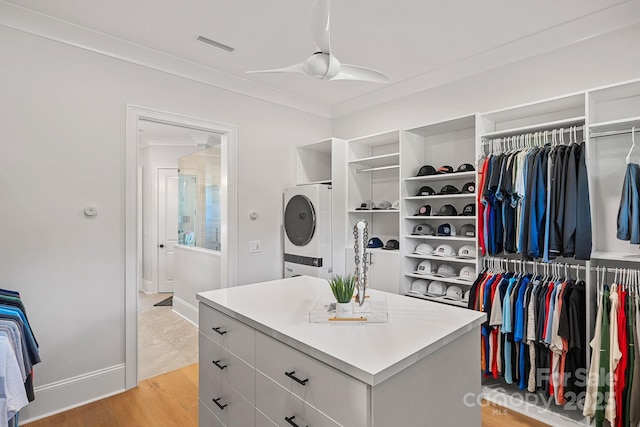 1405 Waxhaw Marvin Rd, Waxhaw, NC 28173 - walk in closet featuring stacked washer / drying machine, a ceiling fan, and light wood-type flooring