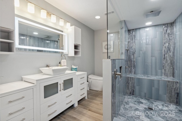 3807 Sweetgrass Ln, Charlotte, NC 28226 - full bathroom featuring vanity, toilet, tiled shower, wood finished floors, and recessed lighting