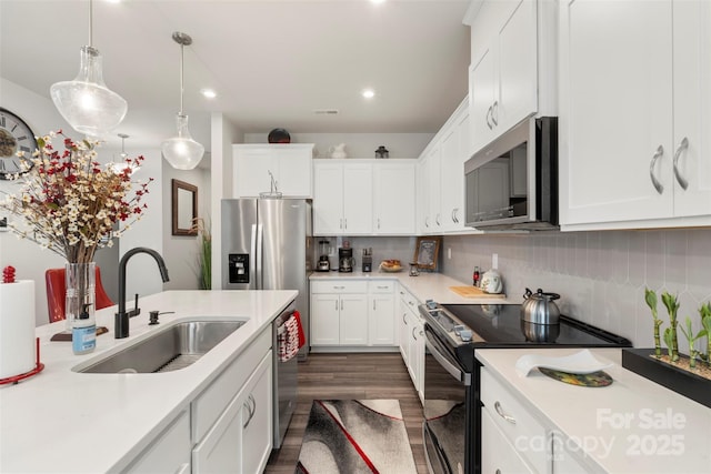 13327 Savaine St, Charlotte, NC 28278 - kitchen featuring stainless steel appliances, a sink, light countertops, dark wood finished floors, and recessed lighting