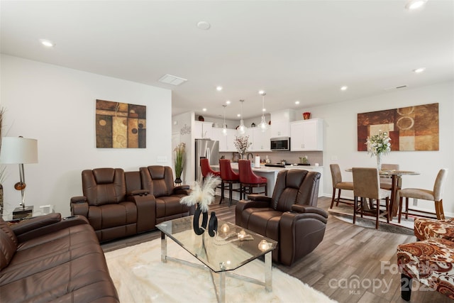 13327 Savaine St, Charlotte, NC 28278 - living area with light wood finished floors and recessed lighting