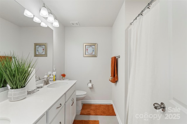 13327 Savaine St, Charlotte, NC 28278 - bathroom featuring double vanity, toilet, baseboards, and tile patterned flooring
