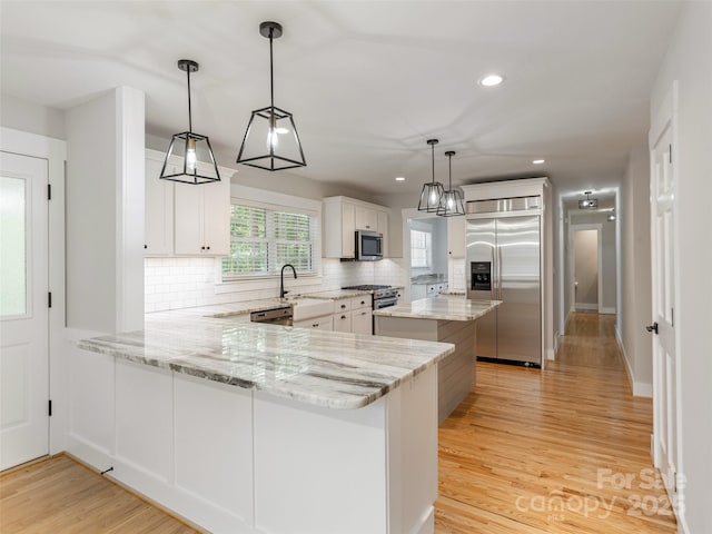 330 Balsam Rd, Hendersonville, NC 28792 - kitchen featuring premium appliances, decorative backsplash, light wood-type flooring, recessed lighting, and a center island