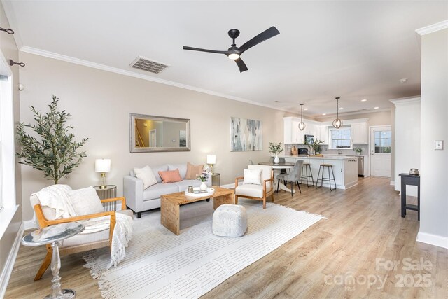 121 Quality Dr, Mount Holly, NC 28120 - living room featuring light wood-type flooring, crown molding, recessed lighting, baseboards, and a ceiling fan