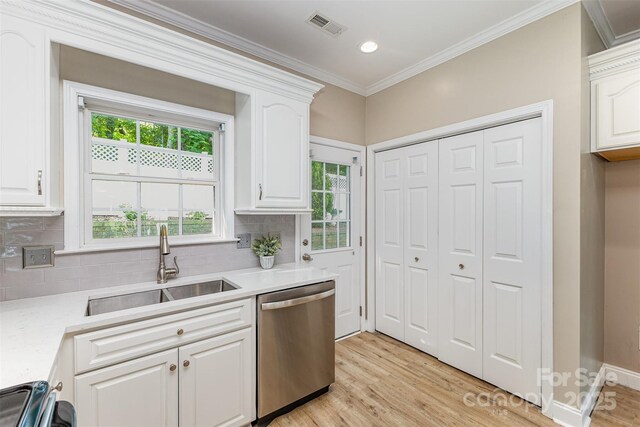 121 Quality Dr, Mount Holly, NC 28120 - kitchen with stainless steel dishwasher, a sink, light wood-style flooring, decorative backsplash, and white cabinetry