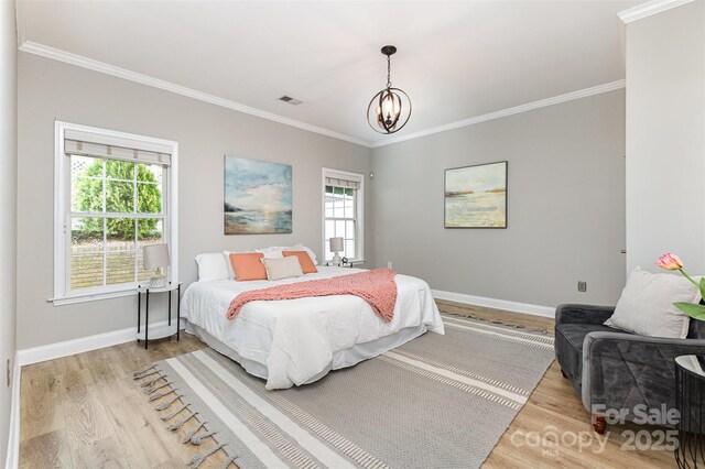 121 Quality Dr, Mount Holly, NC 28120 - bedroom featuring light wood-style flooring, ornamental molding, multiple windows, and baseboards