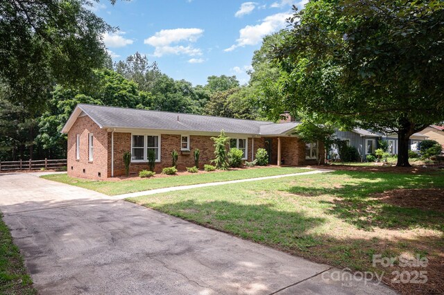 418 Melody Ln, Shelby, NC 28152 - ranch-style house featuring brick siding, concrete driveway, a chimney, and roof with shingles