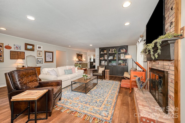 418 Melody Ln, Shelby, NC 28152 - living room with a brick fireplace, wood finished floors, recessed lighting, and wainscoting