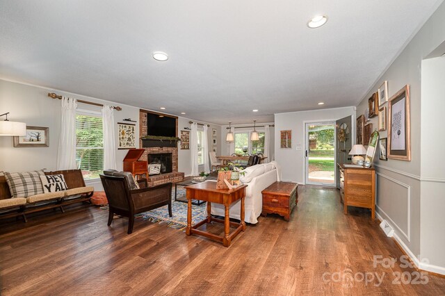 418 Melody Ln, Shelby, NC 28152 - living room featuring wood finished floors, healthy amount of natural light, recessed lighting, and a brick fireplace
