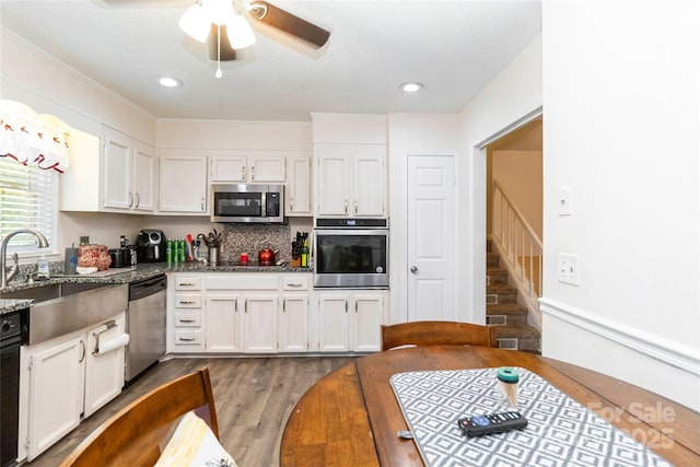 1104 Colony Ct, Gastonia, NC 28056 - kitchen with stainless steel appliances, a sink, white cabinetry, stone counters, and recessed lighting
