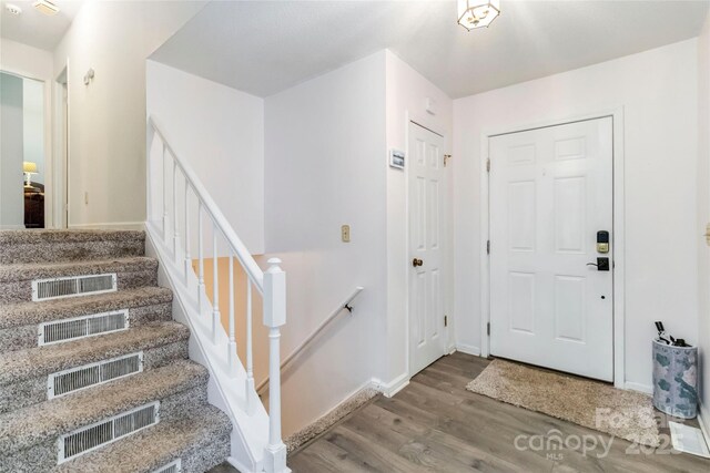 1104 Colony Ct, Gastonia, NC 28056 - foyer with wood finished floors, baseboards, and stairs