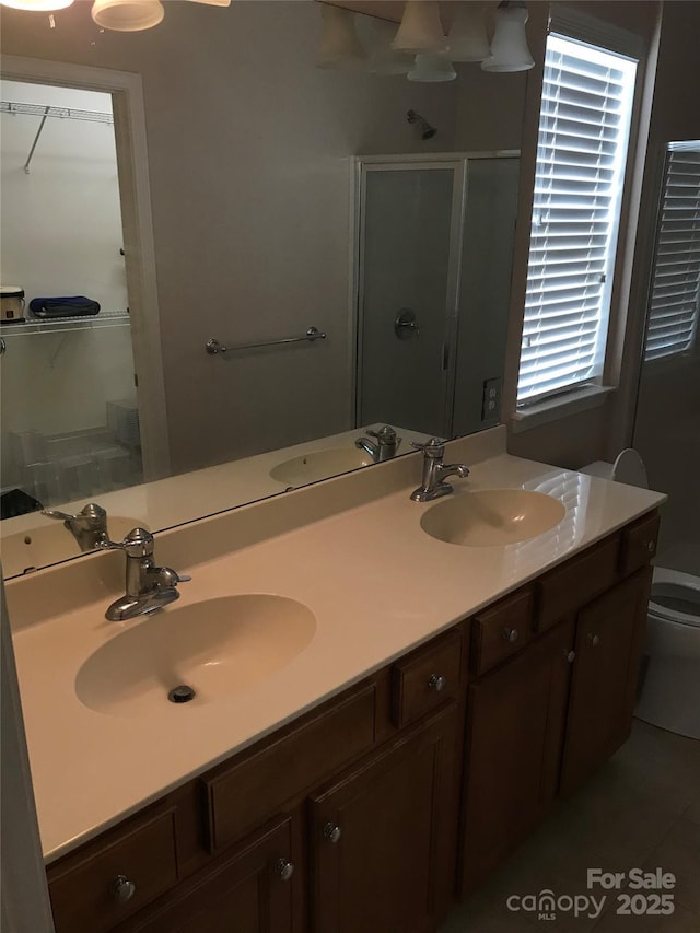 19157 Mallard Dr, Fort Mill, SC 29707 - bathroom featuring a stall shower, double vanity, toilet, and tile patterned floors