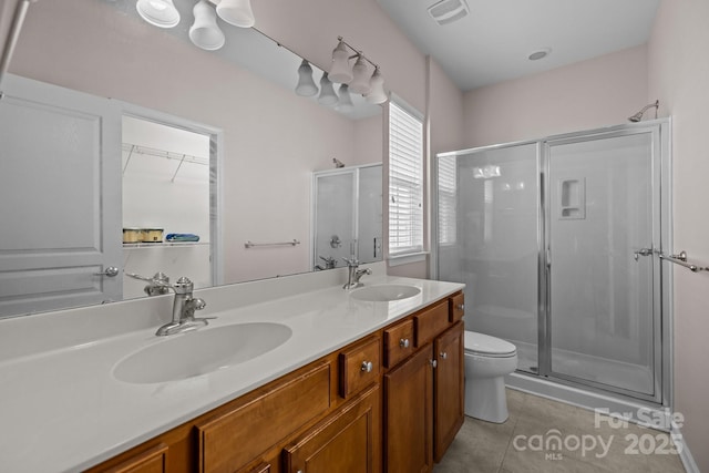 19157 Mallard Dr, Fort Mill, SC 29707 - bathroom featuring a shower stall, tile patterned floors, toilet, and double vanity