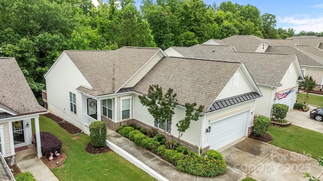 19157 Mallard Dr, Fort Mill, SC 29707 - view of front of house featuring a standing seam roof, concrete driveway, metal roof, a front yard, and a garage