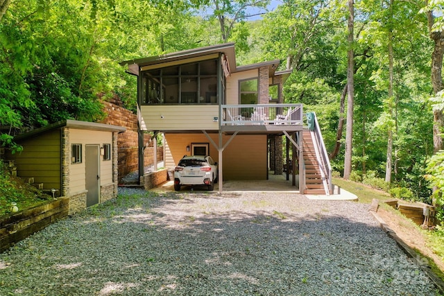 145 Old Still Rd, Maggie Valley, NC 28751 - back of house with stairs, a sunroom, driveway, a wooden deck, and a carport