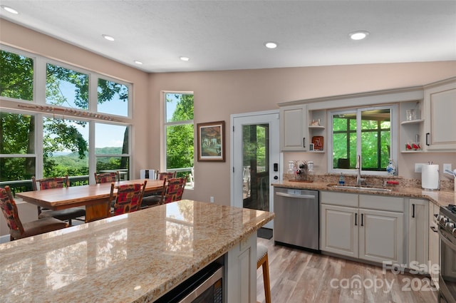 145 Old Still Rd, Maggie Valley, NC 28751 - kitchen with stainless steel dishwasher, open shelves, a sink, light wood finished floors, and light stone countertops