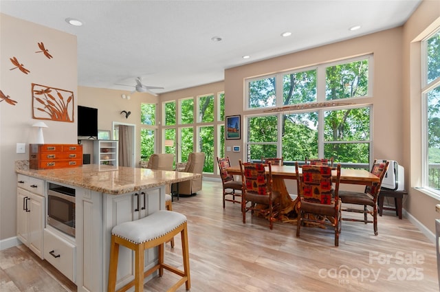 145 Old Still Rd, Maggie Valley, NC 28751 - kitchen featuring stainless steel microwave, white cabinets, light wood-style flooring, and recessed lighting
