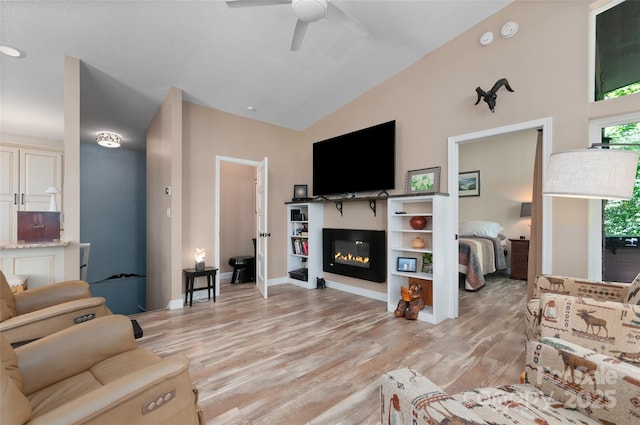 145 Old Still Rd, Maggie Valley, NC 28751 - living area with a ceiling fan, light wood-style floors, a glass covered fireplace, and lofted ceiling