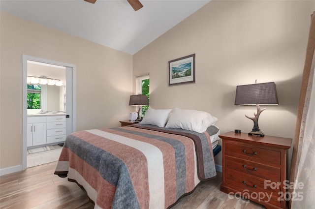 145 Old Still Rd, Maggie Valley, NC 28751 - bedroom with light wood-type flooring, lofted ceiling, multiple windows, ensuite bath, and ceiling fan