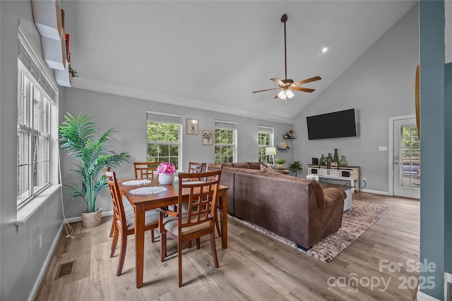 7830 Sarah Dr, Denver, NC 28037 - dining room with baseboards, light wood-style flooring, ceiling fan, high vaulted ceiling, and crown molding